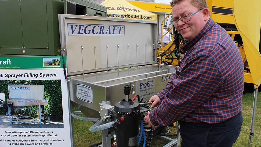 Adam McDonald demonstrates the Pentair Hypro Cleanload Nexus closed transfer system fitted to a four-nozzle, Vegcraft ProFill sprayer filling station