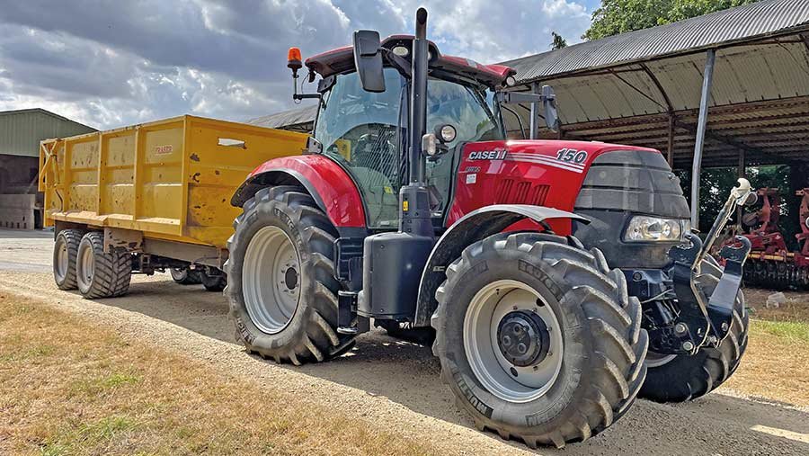 Tractor and trailer in a farmyard