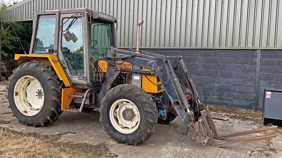 Old tractor beside a shed