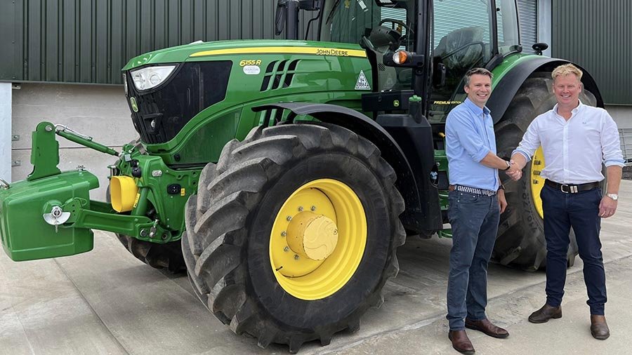 Ben Turner (left) with Ian Double day in front of a John Deere 6R 155 tractor