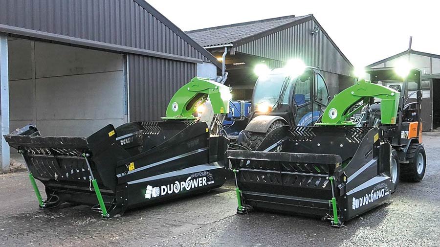 Two bale spreaders in a farmyard