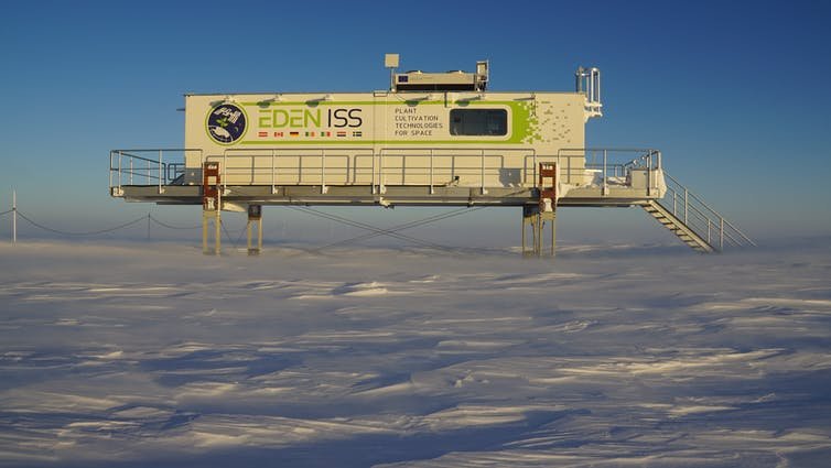 A white building above a frozen landscape.