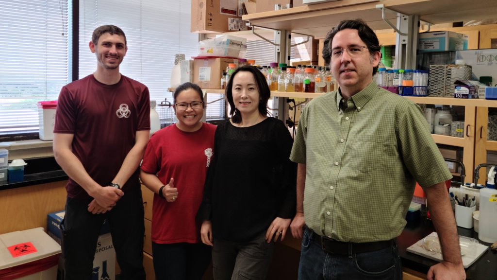 Two men and two women, personnel from the Center for Phage Technology who were involved in recent study, stand in a lab setting