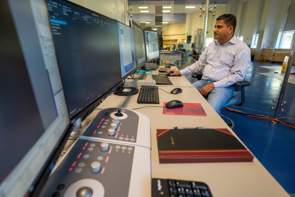 Man working at a set of computer displays.