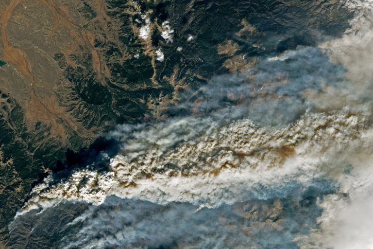 Colorado's East Troublesome Fire, on October 22, 2020, which jumped the Continental Divide and eventually became Colorado's largest fire on record, at nearly 200,000 acres. NASA Earth Observatory images by Lauren Dauphin, using Landsat data from the U.S. Geological Survey.