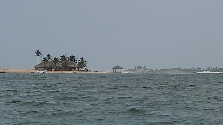 A hotel, now closed, where the Volta River meets the Atlantic Ocean. Image by Erica Ayisi for Mongabay.