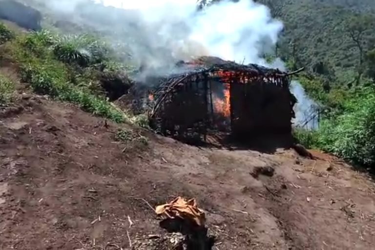 A screenshot from a video, taken by a Mutwa community member, in which Batwa homes were burnt by park guards.