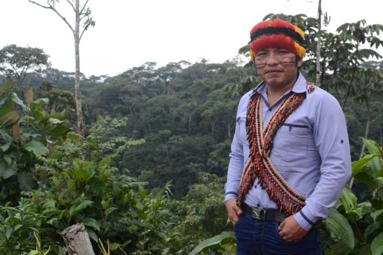 Efren Nango of the Shiwiar Nationality and education officer of CONFENIAE, wears a crown representing authority and necklace showing the natural wealth of the territory