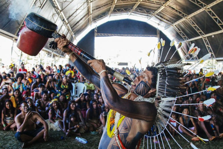 An Indigenous man practices a ritual in front of a large crowd during the Free Land Camp 2022. Around 6,000 Indigenous people gathered in Brasília where they debated current issues that are affecting Indigenous and traditional peoples’ rights.