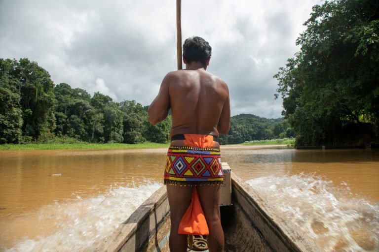 Indigenous Embera in boat crossing a river in Gamboa, Panama. Photo credit: Ricardo Canino. Licensed via Adobe Photo Stock