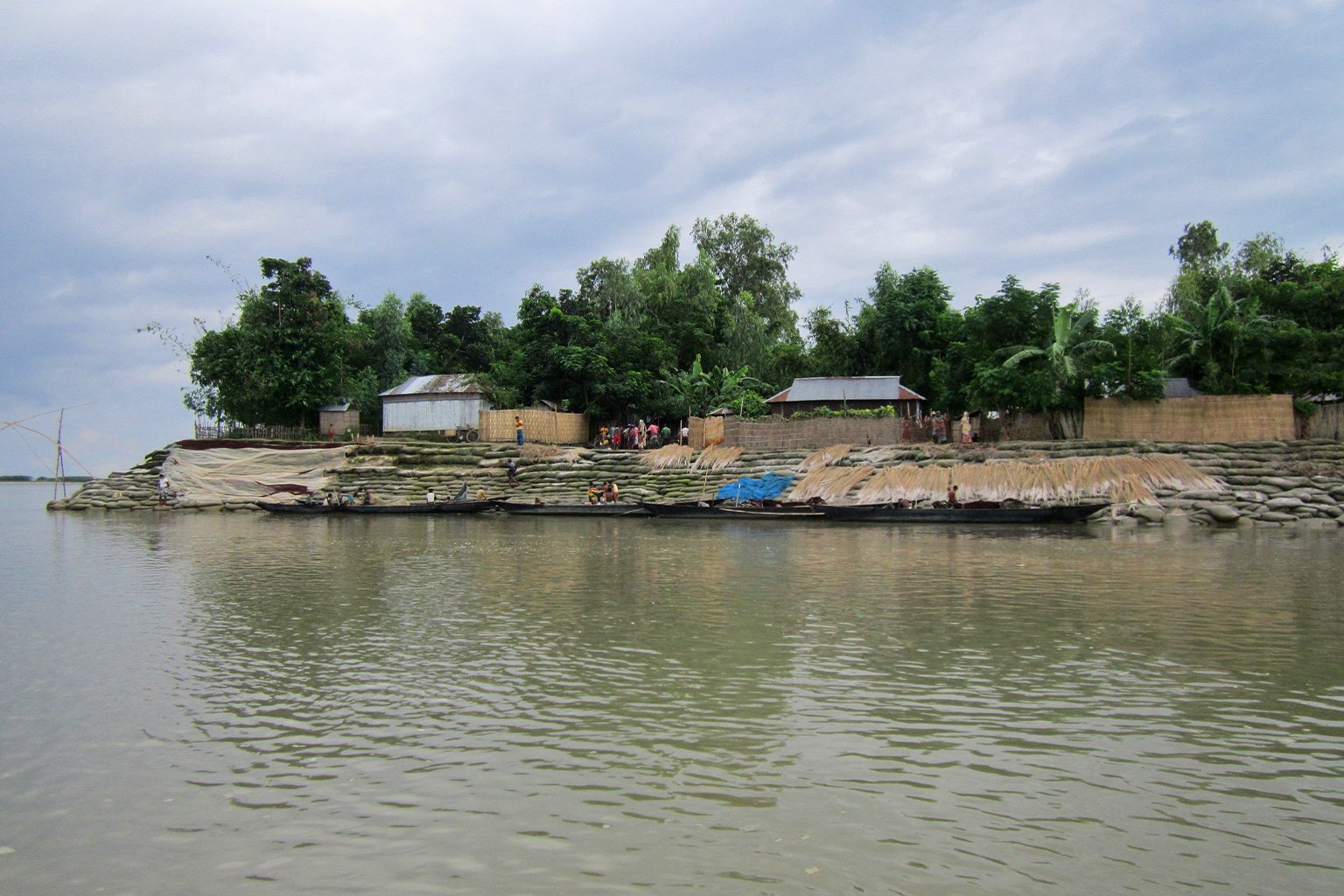 Sacks of earth arranged bordering a char land to prevent the river from eroding the land.