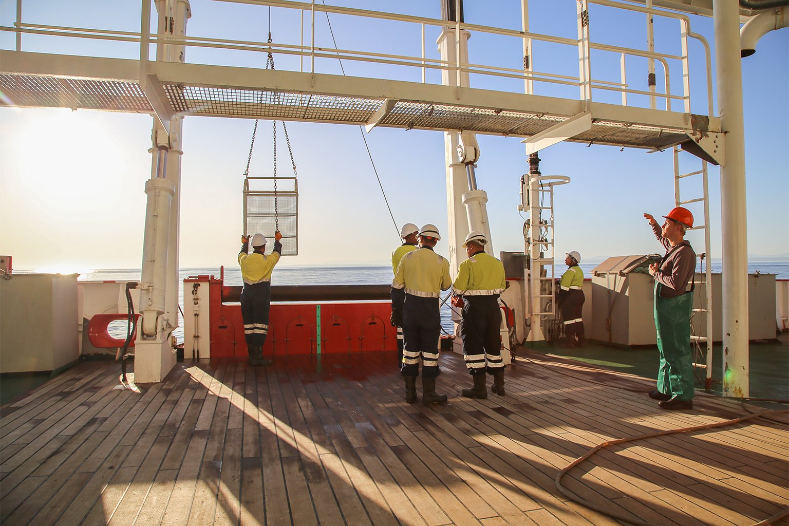 The crew deploys a dredge to gather sediment samples.