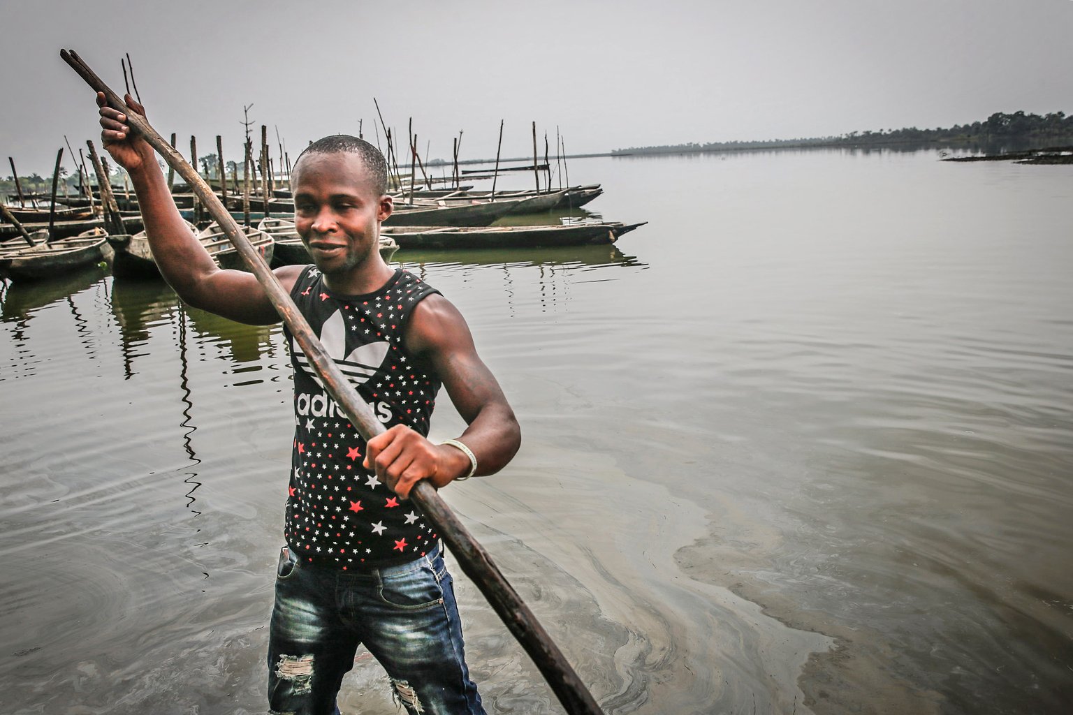 A man in polluted water in Bodo