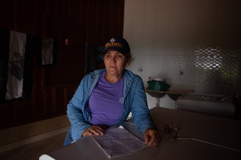 Dorcas Cruz, one of the settlers illegally occupying a slice of land in Apyterewa Indigenous Reserve, poses with a Funai-issued appraisal of the land she is occupying. She refuses to leave without compensation for her home and the 17,000 cocoa trees she has planted. Photo by Ana Ionova for Mongabay.